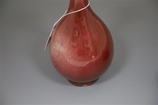 A Chinese sang de boeuf lang yao garlic neck vase, 19th century, H.24cm, two small foot chips, wood stand